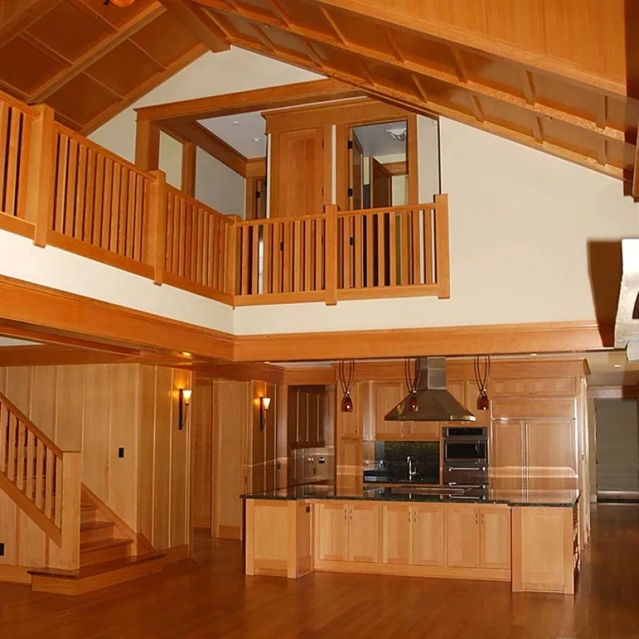 Interior carpentry featuring wood-paneled walls with loft and exposed beams