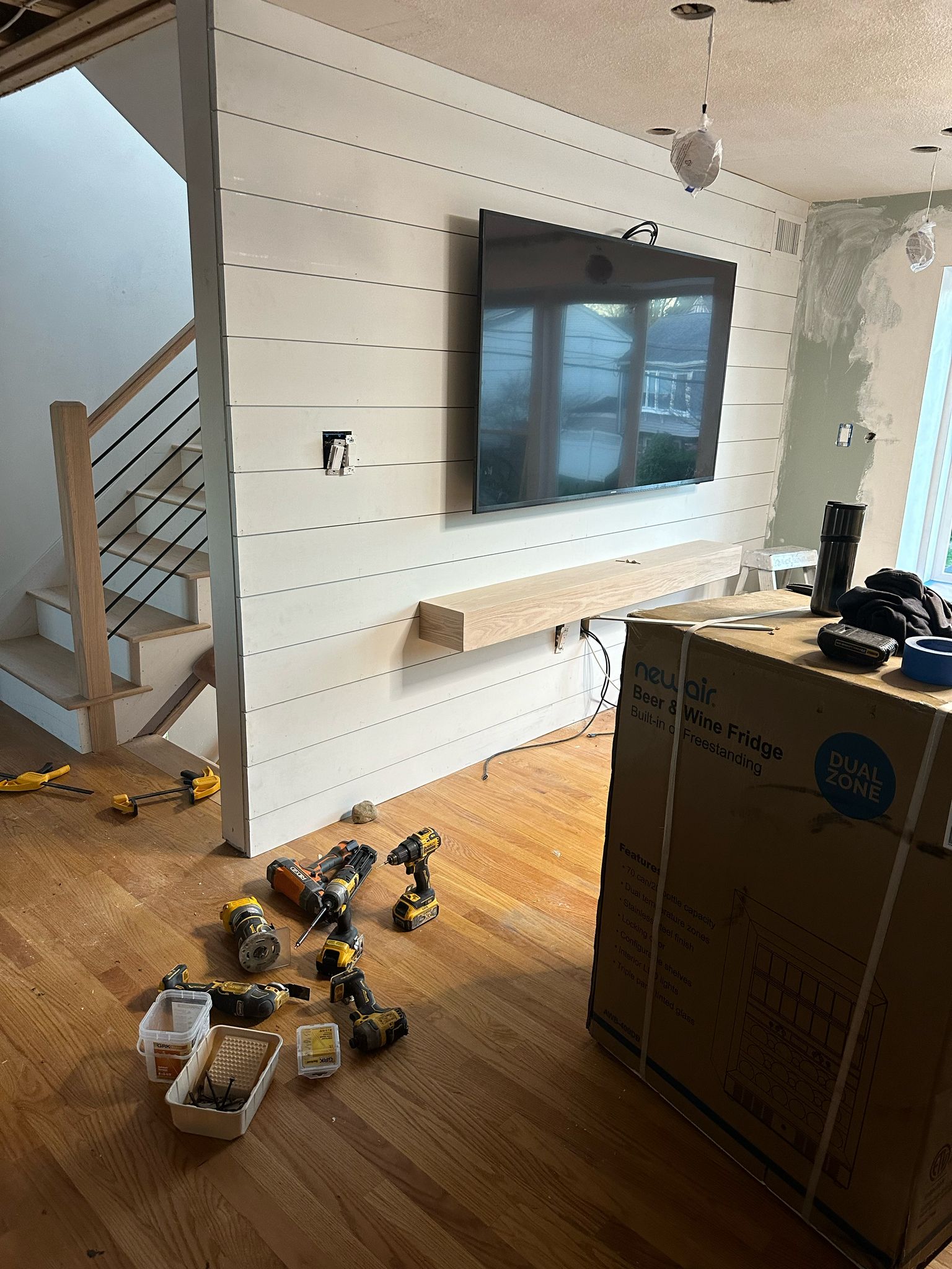 Shiplap wall installation with floating shelf