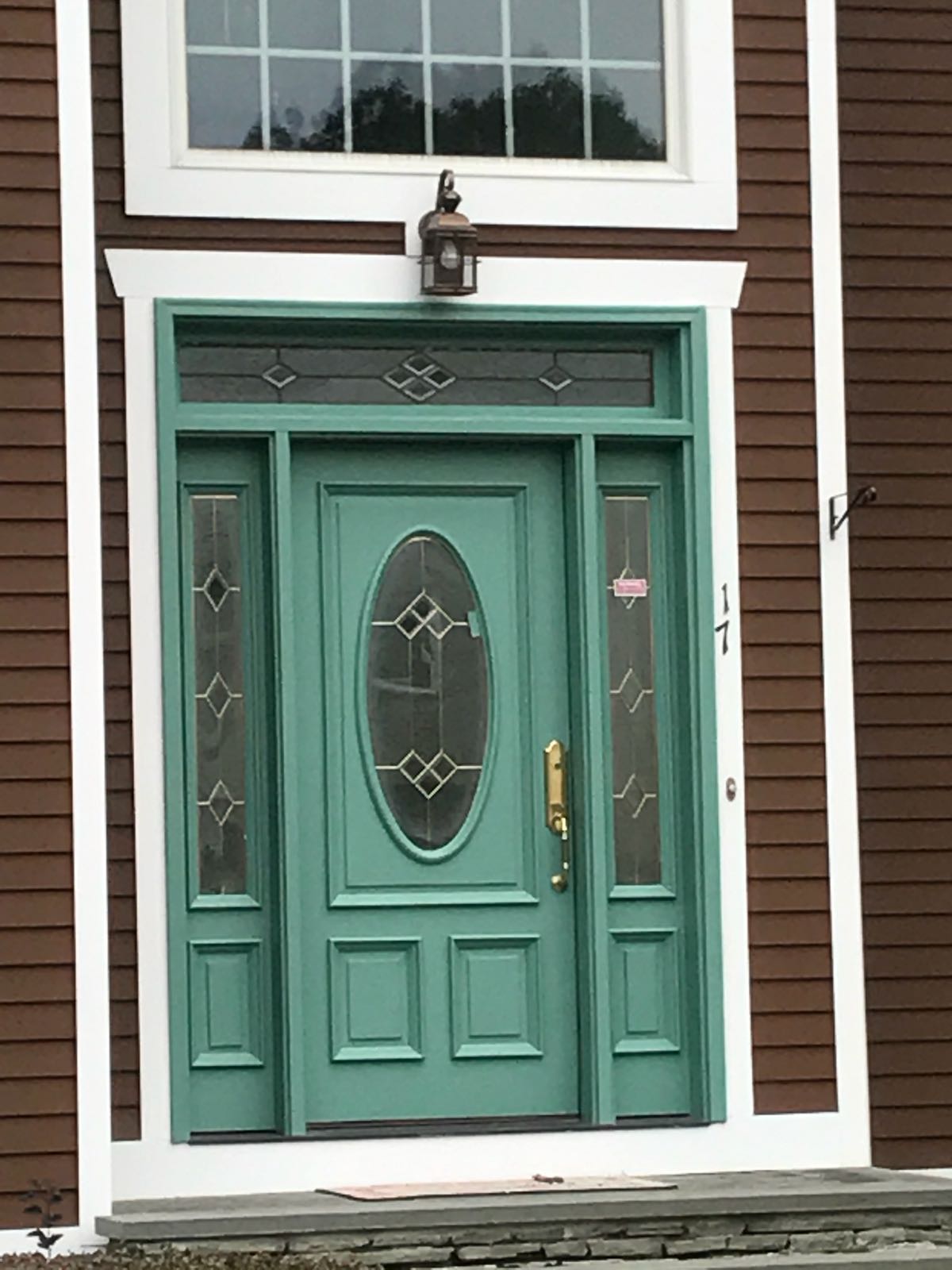 Beautiful turquoise entry door with decorative glass panels