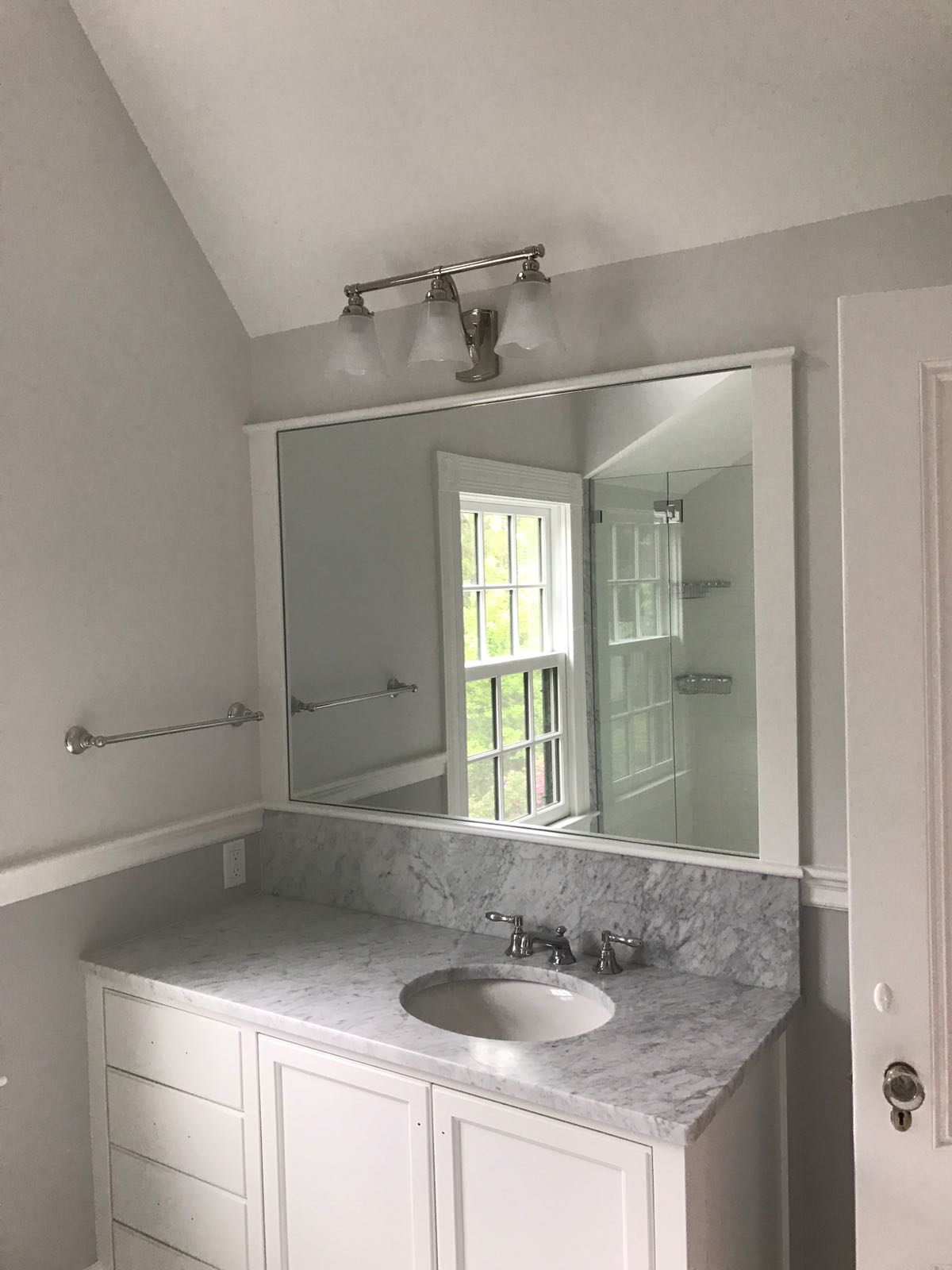 Elegant bathroom vanity with marble countertop and framed mirror