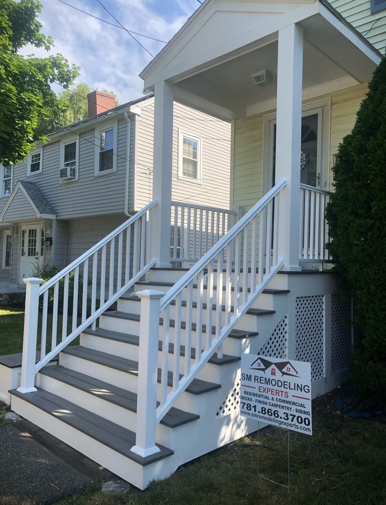 Front porch with covered entry and white railings