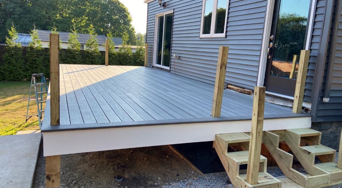 Partially completed deck with gray composite decking installation