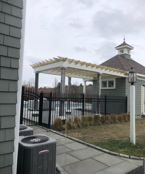 White pergola structure beside residential pool area