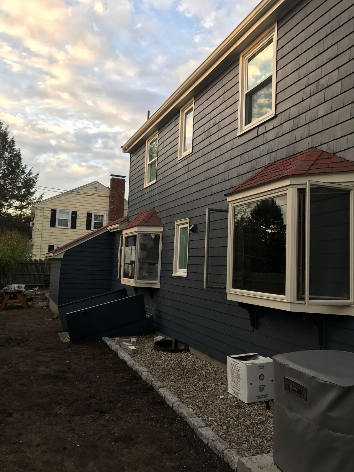 House exterior renovation with bay windows and new siding