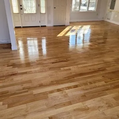 Polished oak hardwood flooring installation with high-gloss finish