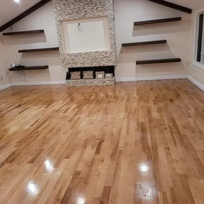 Living room hardwood flooring with custom built-in shelving and fireplace