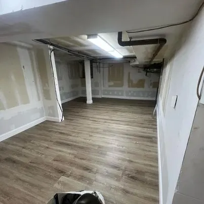 Finished basement living space with modern luxury vinyl plank flooring