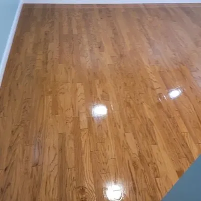 Light maple hardwood flooring with exceptional high-gloss reflective finish