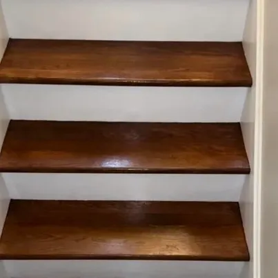 Custom stair refinishing in rich dark walnut with professional polish