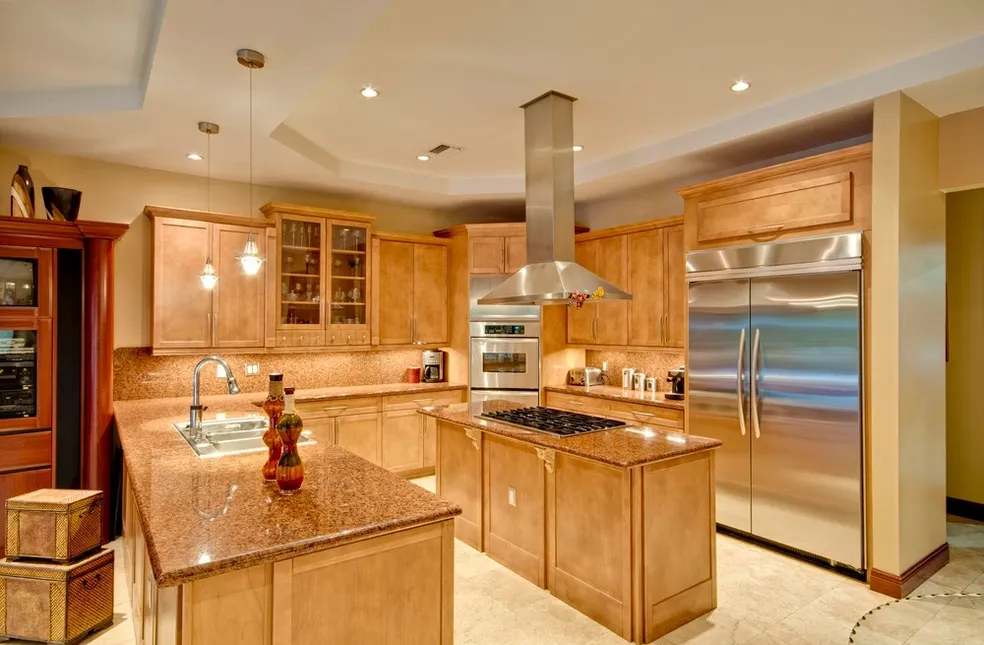 Elegant kitchen with maple cabinets, dual islands, and professional stainless appliances