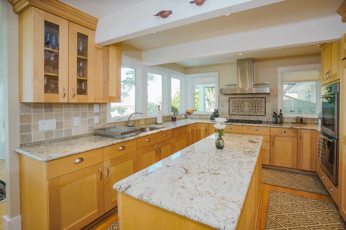 Beautiful kitchen with natural maple cabinets, granite countertops, and center island