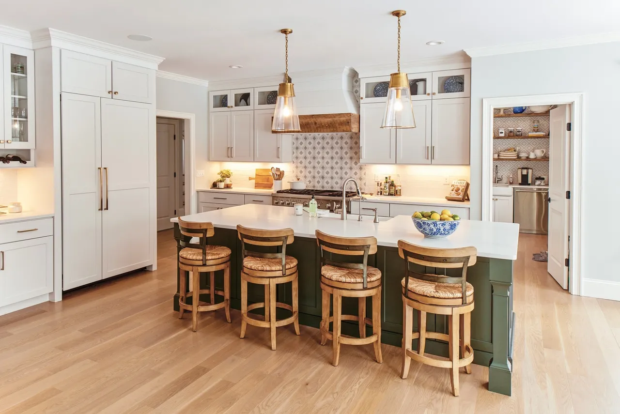 Rustic-modern kitchen with natural wood cabinets, exposed beams, and custom island
