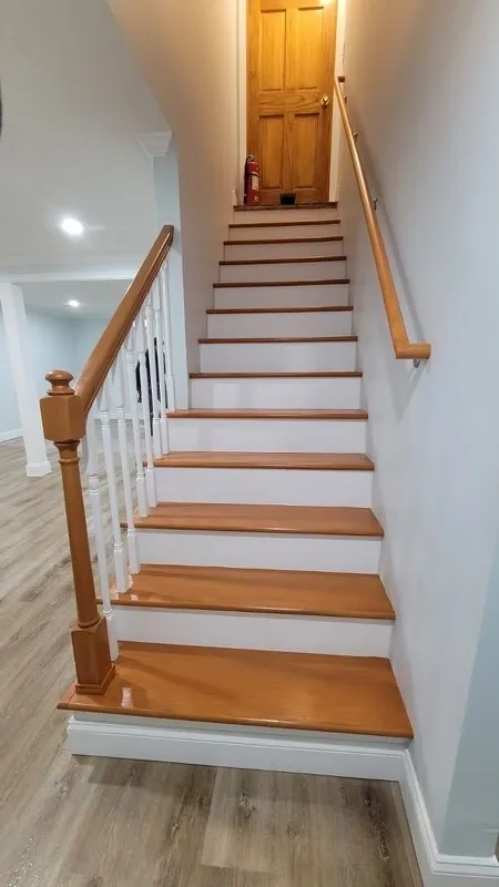 Beautiful staircase renovation with hardwood treads and white risers